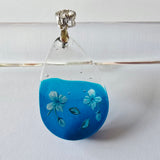 Beautiful blue and clear resin pendant with flower details