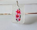 Stunning clear glitter resin pendant with flowers