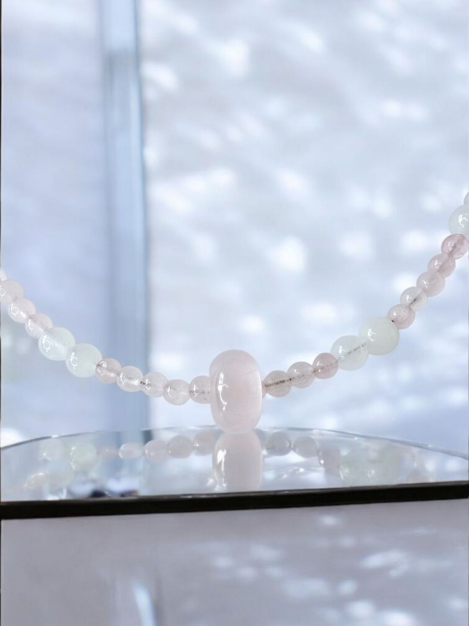 Rose Quartz necklace with moonstone and white jade. features a rose quartz donut